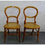 Two balloon back side chairs, the shaped seats with cane work on turned supports and stretchers,