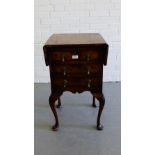 A burr walnut drop flap side cabinet, the moulded top over three long drawers with a shaped apron