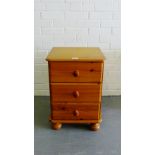 A pine three drawer bedside