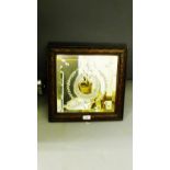 A horseshoe engraved wall mirror on a square oak carved frame, 39 x 39cm