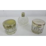 A Birmingham silver topped and cut glass scent bottle together with two toilet jars (3) tallest 5cm