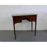 A mahogany side table, the rectangular moulded top over two short drawers and shaped frieze raised