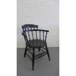 A black painted spindle back armchair with solid circular seat on turned supports and stretchers, 80