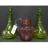 A pair of green glass and enamel decorated decanters and stoppers together with a dimple cranberry