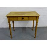 A pine kitchen table, the rectangular top over a single drawer on turned supports, 77 x 91cm