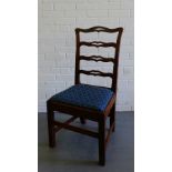 A 19th century mahogany ladder back chair with a curved top rail and slip in upholstered seat on