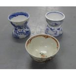 A Chelsea red anchor 18th century tea bowl, together with a blue and white willow pattern egg cup