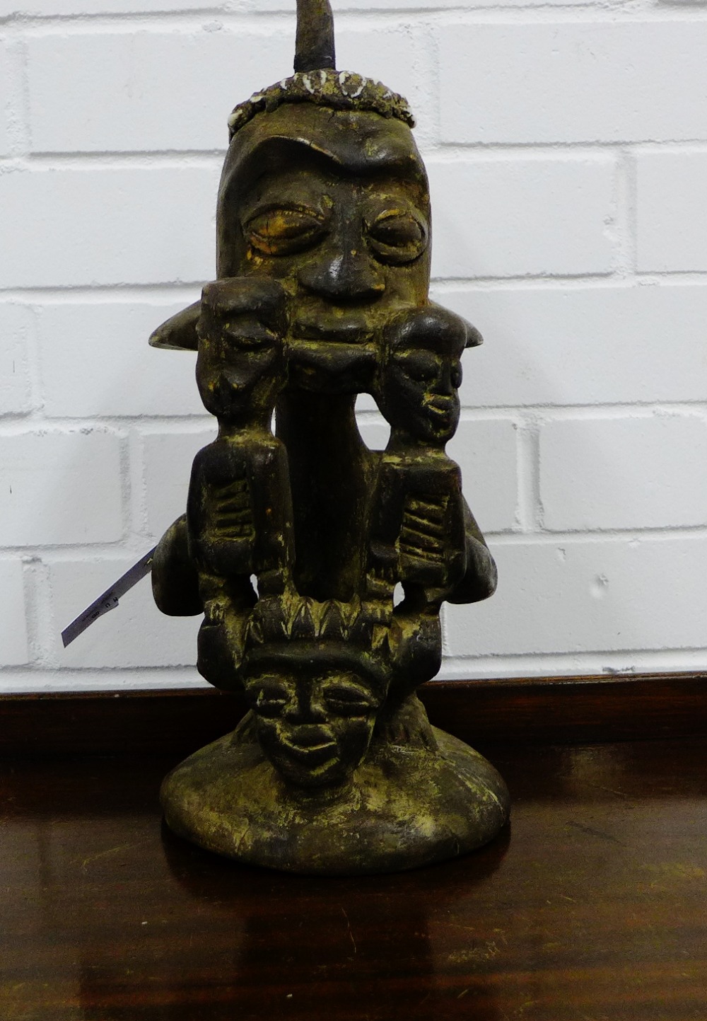 An African hardwood figure with shell inlaid head dress, 42cm high