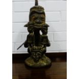 An African hardwood figure with shell inlaid head dress, 42cm high