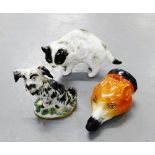 A continental porcelain black and white dog figure, together with a porcelain cat and a fox head