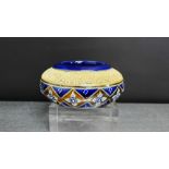 A Royal Doulton stoneware circular pot with a cobalt blue ground and sprig work floral pattern,