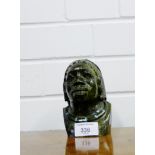 A carved hardstone African bust, 13cm high