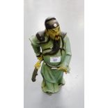 A Chinese green glazed stoneware figure of a Warrior, 34cm high