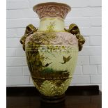 A floor standing flared rim baluster vase with rams head gilded handles to side with fluted and