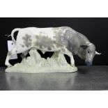 A Lladro figure of a Bull, modelled standing on a naturalistic green base, 33 x 17cm