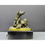 A patinated bronze boy and dog figure group mounted upon an ebonised plinth base, 18 x 15cm