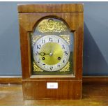 A mahogany cased mantle clock, the brass plate dial with silvered chapter ring and Arabic numerals