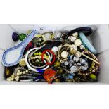 A quantity of costume jewellery to include beads, brooches, necklaces, bangles and buttons etc