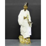 A Craquelure glazed Japanese male figure, modelled standing in traditional dress carrying an axe
