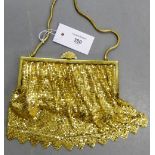 A vintage gilt metal evening bag with paste set clasp