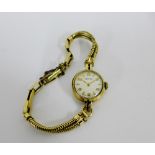 Lady's Vertex 9 carat gold cased cocktail watch, the circular enamel dial with Arabic numerals, on a