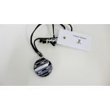 Vetro di Murano black and white glass pendant of circular form, suspended on a black leather cord