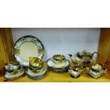 A Japanese Noritake style tea set painted with flowers and foliage with gilt highlights and gilded
