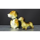 A Midwinter Dachshund figure together with a Staffordshire model of a seated dog, tallest 10cm, (2)