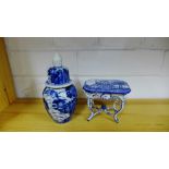 A small blue and white porcelain table painted with figures and modelled in the Rococo style