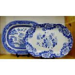 A Staffordshire blue and white 'Willow' patterned ashet, together with a floral blue and white ashet