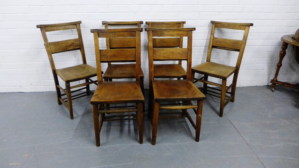 A set of six Edwardian oak bible chairs with spar back and solid seats on turned supports and