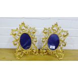 A pair of gilt metal framed mirrors with pierced foliate frames and oval plates (2)