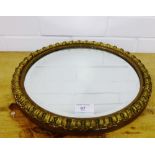 A circular wall mirror with a gilt frame, 35cm diameter