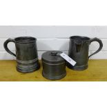 A Victorian pewter quart tankard with spout, another pewter tankard and a Alfred Dunhill pewter