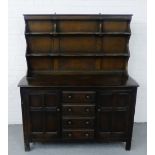 Ercol style dark elm dresser with a shelved plate back over a panelled cupboard door base, 170 x 145