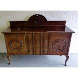 A mahogany ledgeback sideboard, the rectangular top over an arrangement of two serpentine fronted