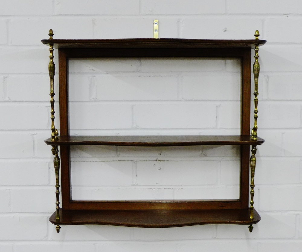 A mahogany wall shelf on turned brass supports, 48 x 54cm