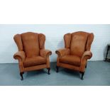 A pair of terracotta upholstered wing armchairs on cabriole mahogany supports, 110 x 90cm (2)