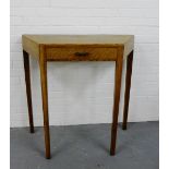 An Art Deco oak side table, the shaped top with a single frieze drawer on straight block supports,