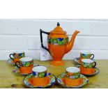 A Bursley ware orange glazed Art Deco coffee set, painted with stylised fruit borders, comprising an