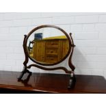 A mahogany framed dressing mirror, the oval plate on shaped side supports, 50 x 49cm