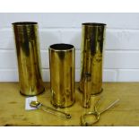 Four brass shell cases, together with a novelty brass safety pin and a pair of tongs (6)