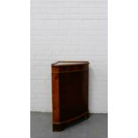 A contemporary yew wood corner cabinet with a cupboard base on bracket supports