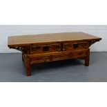 An oriental hardwood coffee table, the rectangular top over pierced carved frieze and pair of