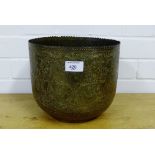 An Eastern brass engraved planter depicting figures, birds and foliate, 25cm diameter