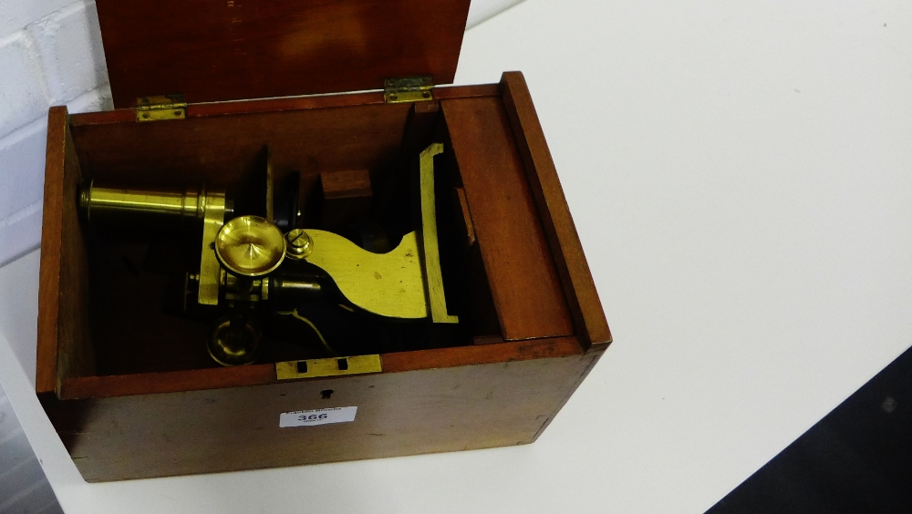 A brass microscope with fitted box