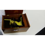 A brass microscope with fitted box