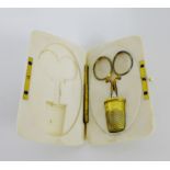 A late 19th century ivory necessaire, the hinged box housing a thimble and small scissors 9 x 6 cm