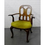 A walnut framed open armchair with pierced back, scrolling arms and upholstered seat on cabriole