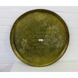 A Middle Eastern brass circular charger with calligraphy and foliate decoration, 59cm diameter